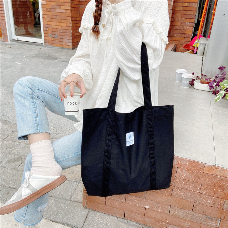 Minimalist canvas tote bag with clean solid-color design