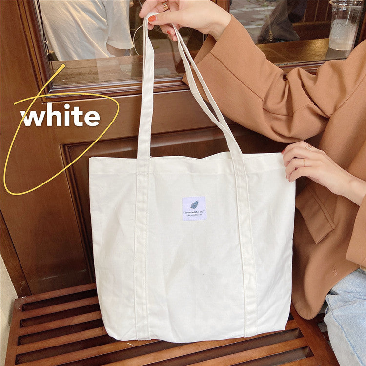 Canvas shoulder tote bag available in multiple neutral colors