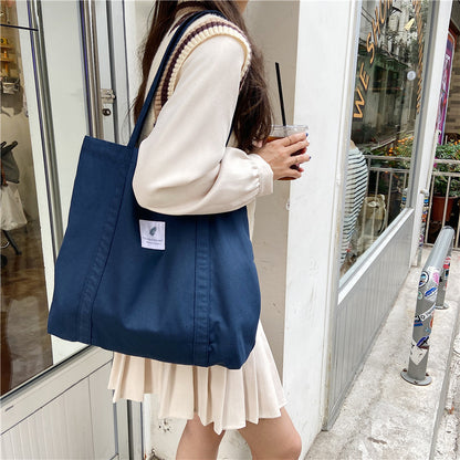 Canvas shoulder tote bag styled for casual daily outings