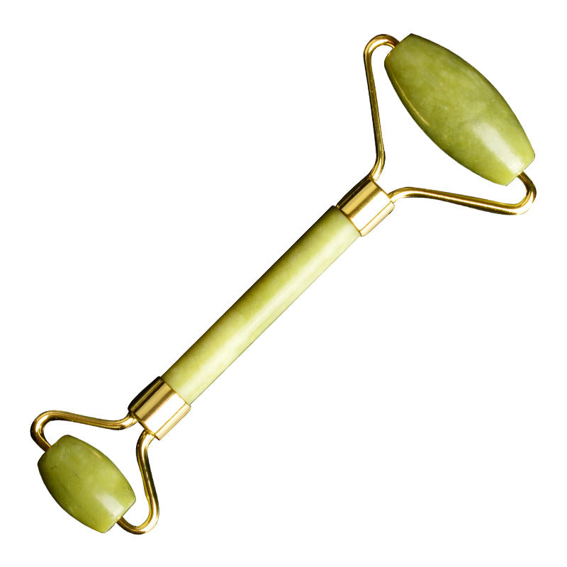 Jade facial massage roller on spa towel