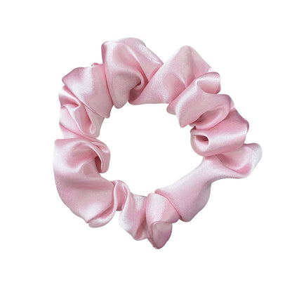 Pink satin scrunchie on a white background