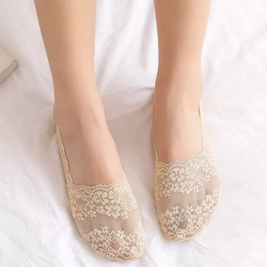 Beige lace socks on a white background