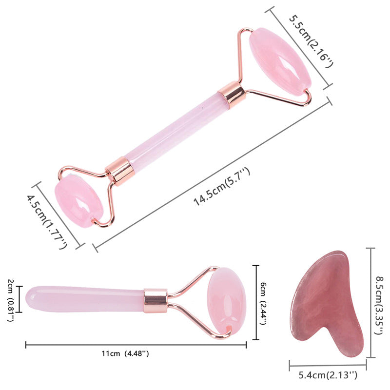 Pink facial roller and gua sha tool with measurements on a white background