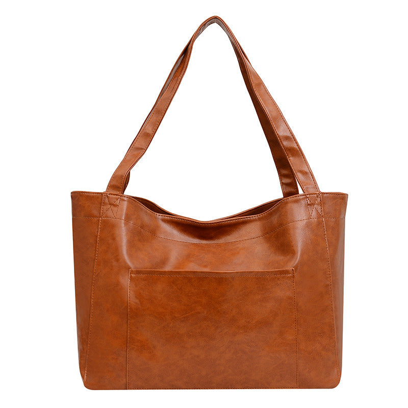 Stitching and contrast color detail on soft retro women’s shoulder bag