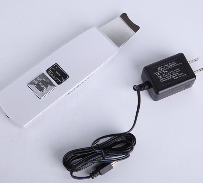 White electronic device with USB ports and a black power adapter on a white background