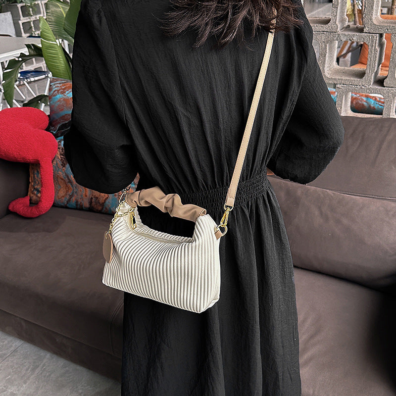 Pleated cloud crossbody bag styled for casual everyday outfits