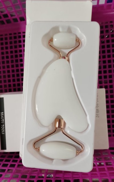 Face massage tools arranged in a clean neutral beauty space